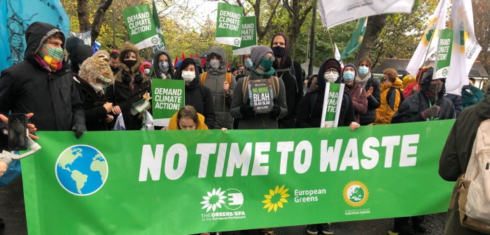 Green party protestors with a banner reading "No time to waste"