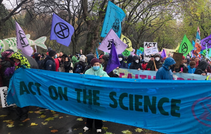Extinction Rebellion protestors with a banner reading "Act on the science"