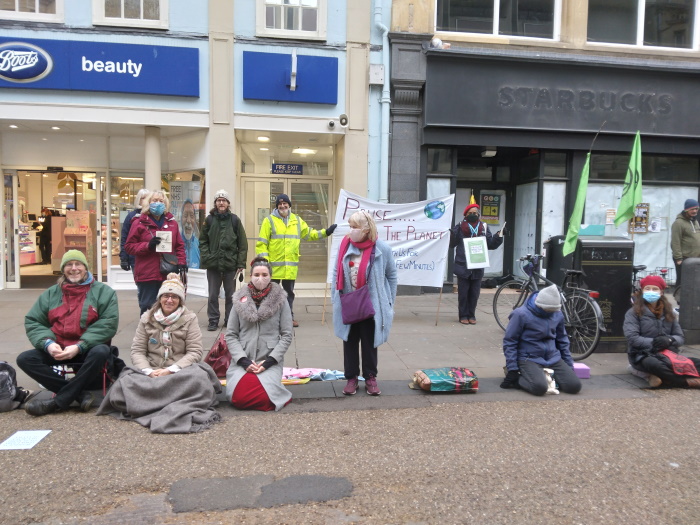 A group of meditators in Cornmarket Street in Oxford.