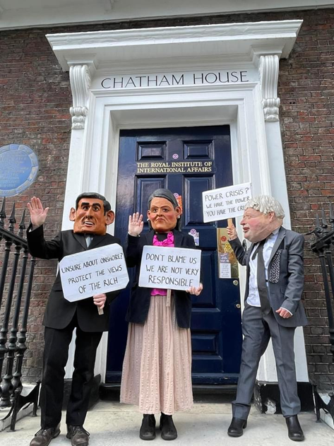 Caricatures of Rish Sunak, Priti Patel and Boris Johnson carry placards:
"Unsure about onshore? Protect the views of the rich"
"Don't blame us. We are not very responsible"
"Power crisis? We have the power. You have the crisis."